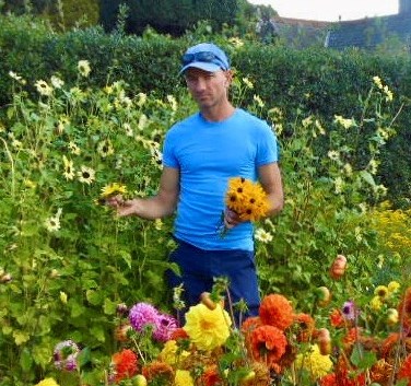 a man standing in a field full of flowers