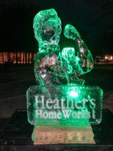 a green light up statue of a cat on top of a sign