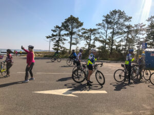 a group of bicyclists are riding in a parking lot