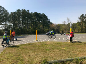 several people on bicycles in a parking lot