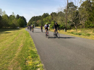 a group of people riding bikes down a road