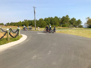 a group of people riding bikes down a curvy road