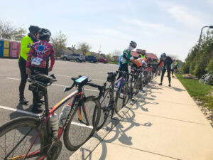 a group of bicyclists are lined up in a parking lot