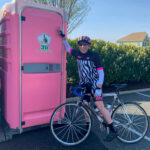 a person on a bike next to a pink cooler