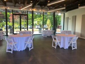 a banquet room with tables and chairs set up for an event