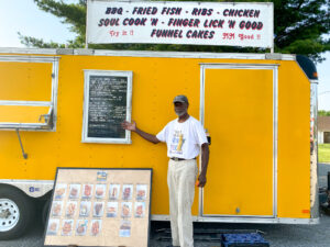a man standing in front of a food truck