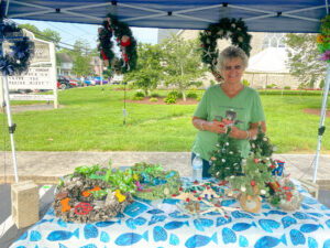 a woman standing next to a table covered in decorations