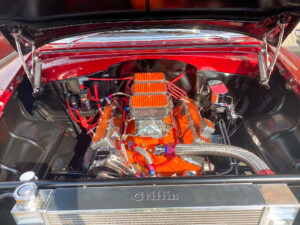 the engine compartment of a classic car with its hood up