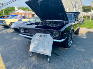 an old muscle car with its hood open