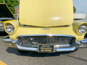the front end of an old yellow car