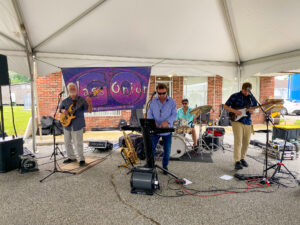 a group of men playing instruments under a tent