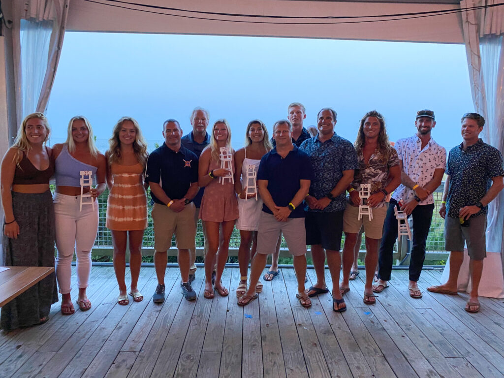 a group of people standing on a wooden deck