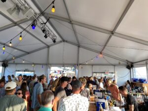 a large group of people standing under a tent