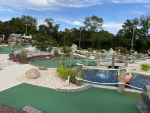 a miniature golf course with people playing on it