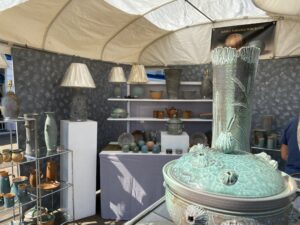 a room filled with lots of vases and lamps