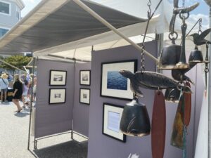 a booth with pictures and bells hanging from it's sides