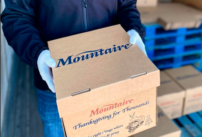 a man holding a box with the word montinaire on it