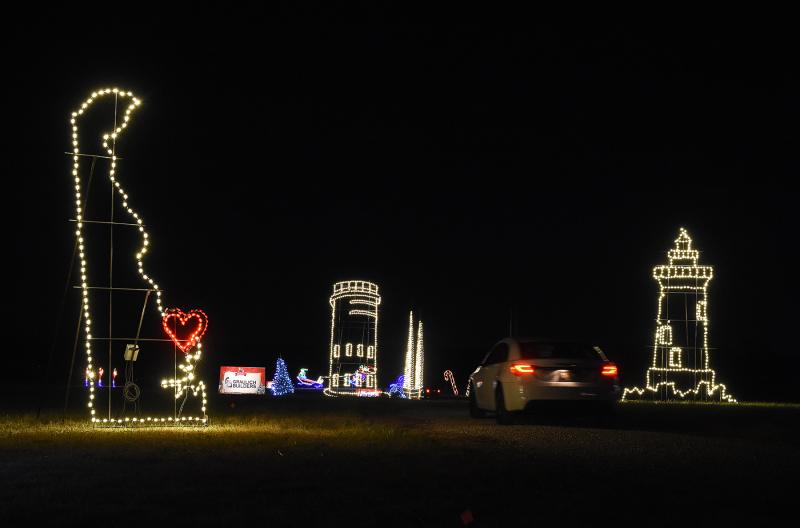 a car parked in front of some christmas lights