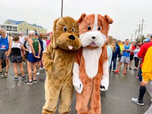 two people dressed as dogs in costume at a race