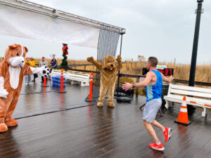 a man running in front of two mascots