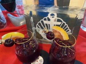 two glasses filled with liquid and fruit on a table