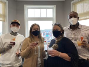 a group of people wearing face masks and drinking drinks