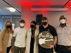 a group of people wearing face masks and holding a sign