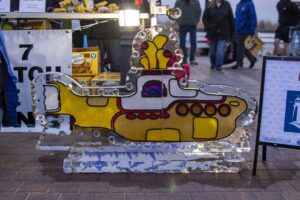 a yellow and white boat shaped ice sculpture