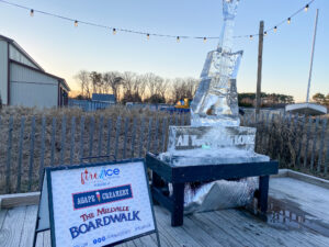 an ice sculpture on a wooden deck with a sign