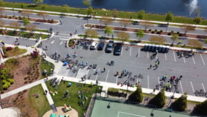 an aerial view of a tennis court and parking lot