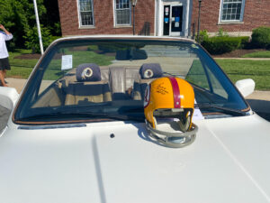a helmet is sitting on the hood of a car