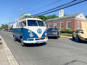 an old vw bus driving down the street