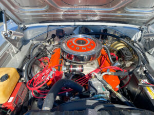 the engine compartment of a car with an orange top