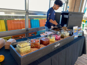 a man standing behind a buffet table filled with food