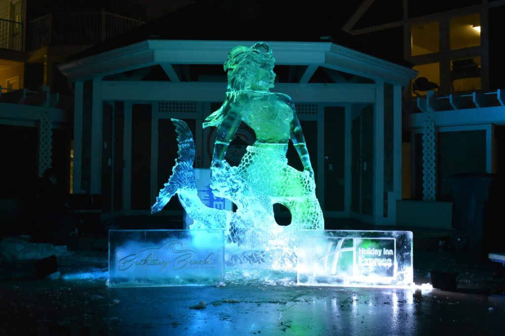 an ice sculpture in front of a house at night