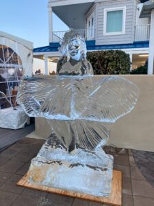 a statue of a man with wings on a wooden block