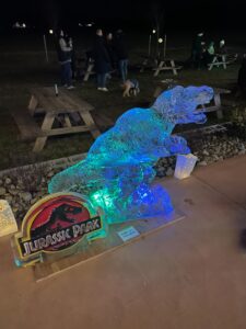 a lit up statue of a dinosaur on a table