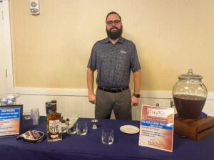 a man standing in front of a table filled with liquor