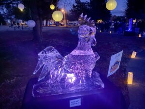 an ice sculpture is lit up at night