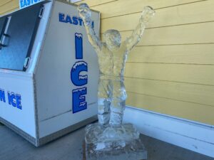 an ice sculpture next to a vending machine