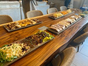 a long wooden table topped with plates of food