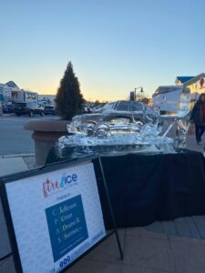 an ice sculpture is displayed on the sidewalk