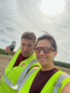 a man and woman in safety vests standing next to each other