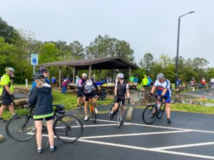 a group of people riding bikes across a parking lot