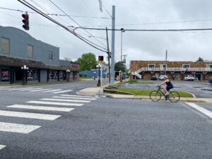 a person riding a bike across a street