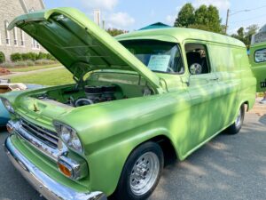 an old green truck with its hood open