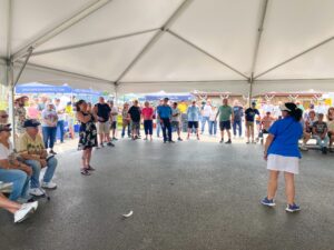 a group of people standing under a tent