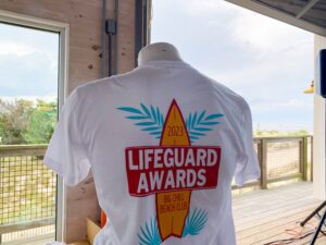a white shirt with the lifeguard awards logo on it