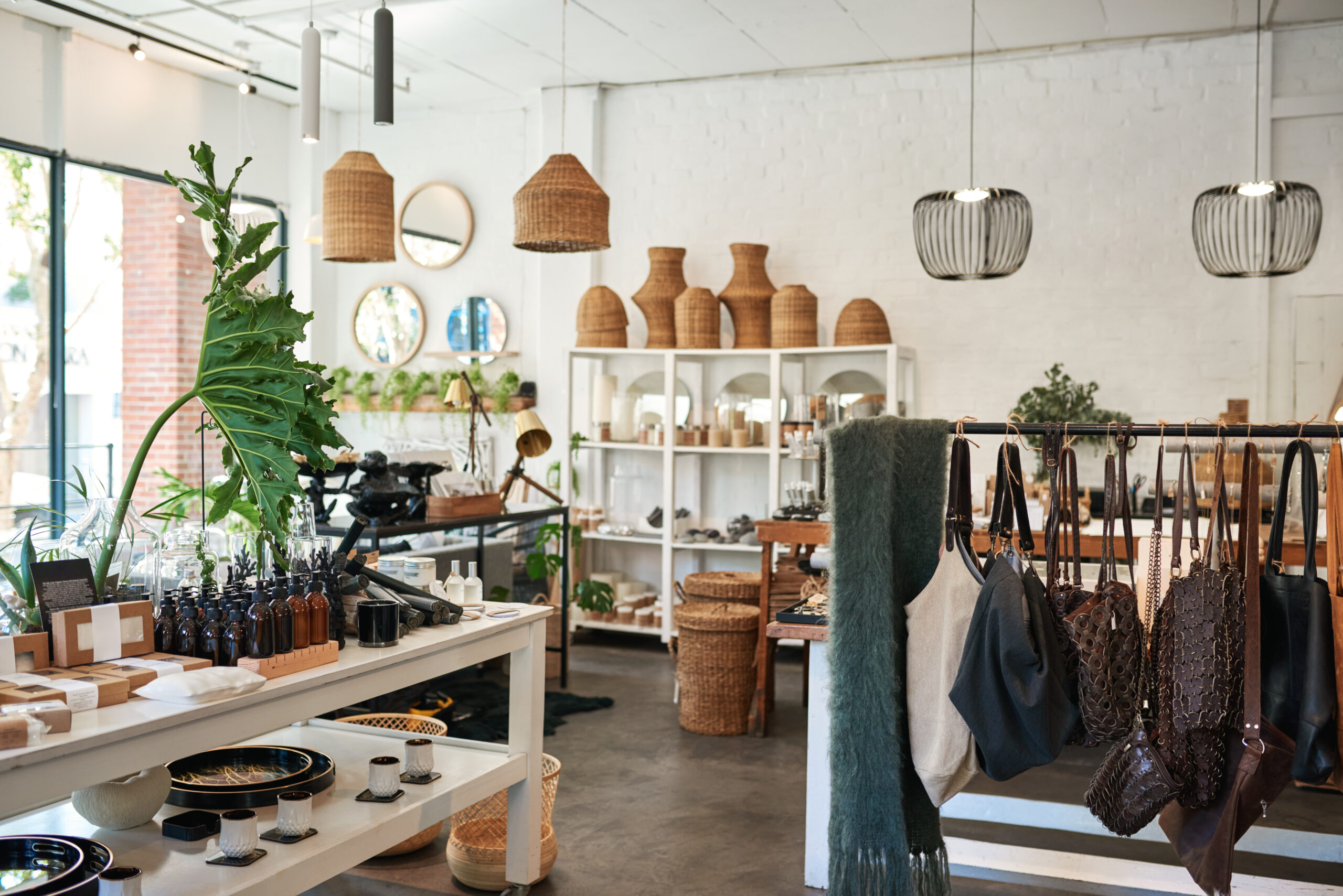 a store with lots of hanging plants and baskets