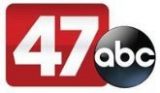 the 477 abc logo with a black and white button